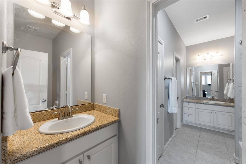 Jack and Jill bathroom with granite countertops.