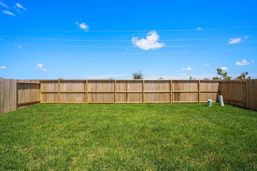 Spacious back yard with sprinkler system.