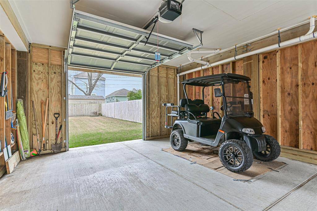 Spacious garage for vehicles and a golf cart.
