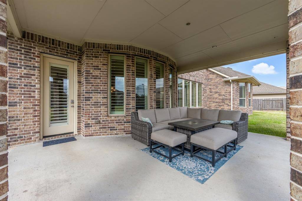 The large covered patio provides a perfect outdoor oasis, offering plenty of space to relax, entertain, or enjoy a meal while being sheltered from the elements.