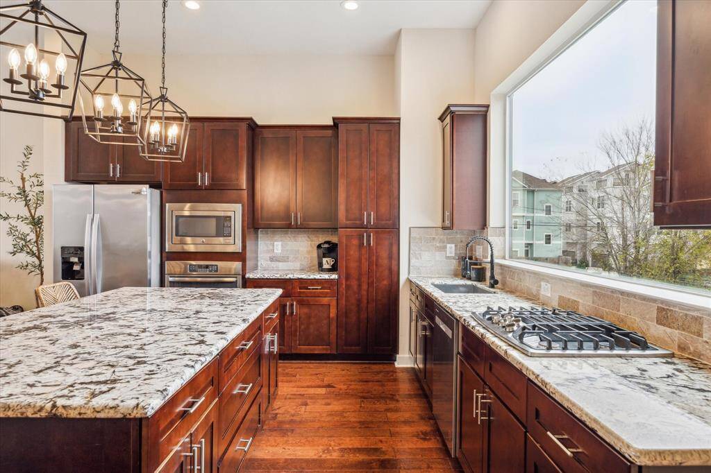 The Kitchen has 42 inch cabinets & features a gas range. The Kitchen Island has double-sided cabinets offering ample storage. Pantry space is located straight ahead through the double stacked cabinets.