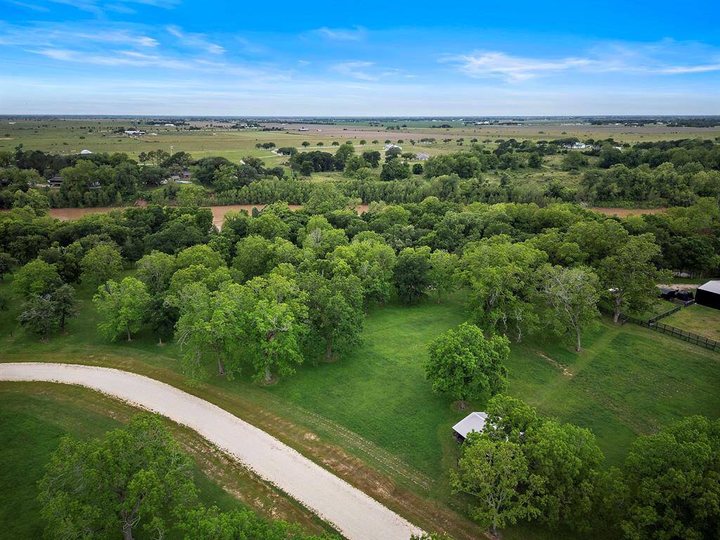 A development that balances giving homeowners private space to stretch while being part of the Fulshear community. This photo is showcasing the view walking from the Brazos River views back towards the additional acreage to build your dream home.