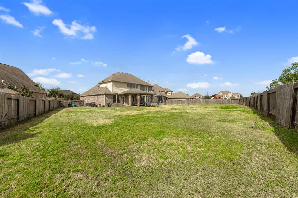 The large backyard is a blank canvas, ready for you to design and transform into your ideal outdoor sanctuary. With endless possibilities, it offers ample space for gardens, a pool, or any other feature you envision.
