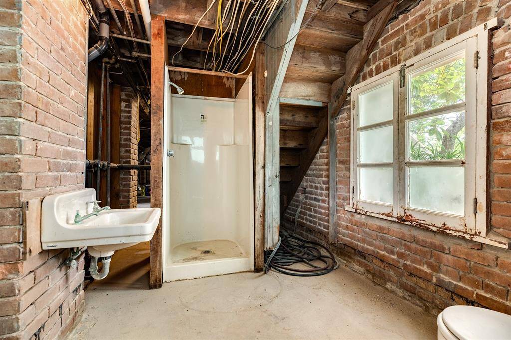 This full-bath is in the basement and the door in here leads to the detached garage.