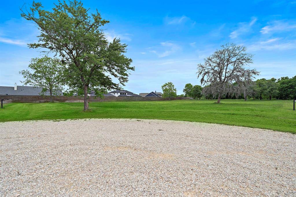 Spacious acreage lot with mature trees, backing up to the scenic Brazos River.