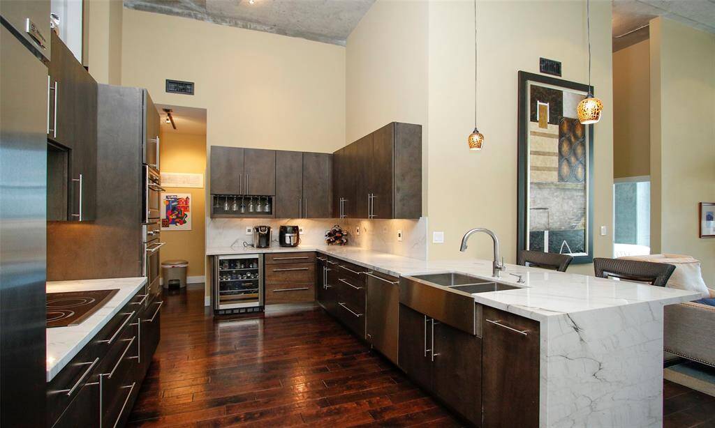 Chef's kitchen features gorgeous natural Quartzite counter tops and backsplash, 42" Custom Cabinetry, and GE Monogram stainless steel appliances and a beverage chiller with built-in wine racks.
