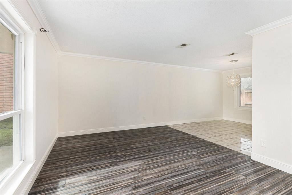 Large flex space that can be used as a home office, formal living, or sitting area.