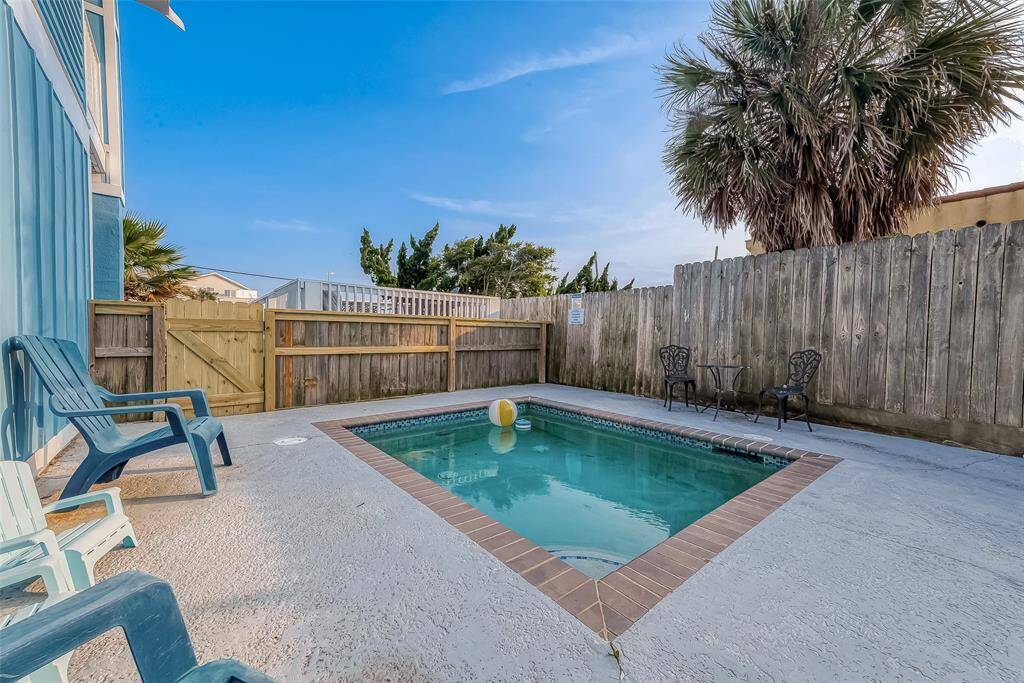 Nestled inside a cozy gate, this cocktail pool and overlooking deck are set up for alfresco entertaining