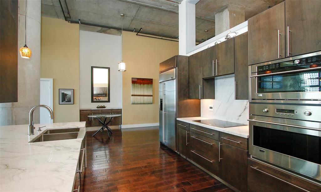 Across from the kitchen is a recessed wall niche with custom cabinetry and Quartzite to compliment the kitchen.  Ideal to create a home bar or use as a buffet table. Options to decorate are limitless in this home!