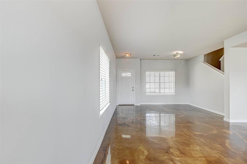 Enter through the front door to a flex space/living room. It would make a great dining room, home office, or downstairs game room.