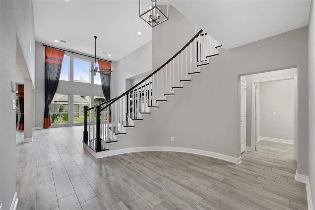 At the center of the home is an upgraded wood step spiral stair case with stained Treads with painted Risers ($6,850.00).  The stained handrails curve with the stairs to create a showpiece that serves with form, function and design interest.
