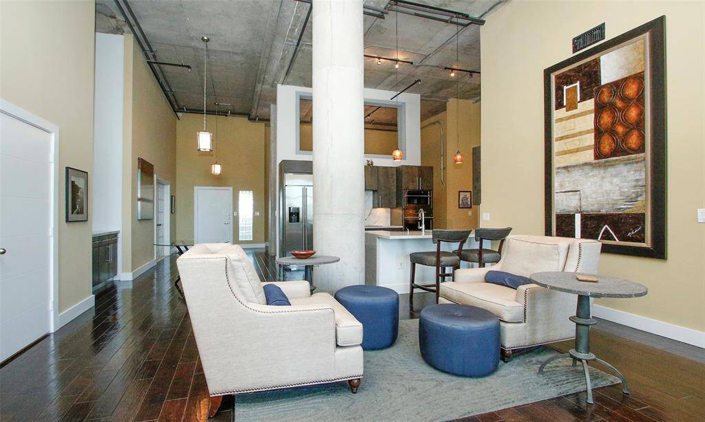 Look at all the great wall space and high ceilings to display your favorite art. Plenty of seating around the kitchen area where your guests always tend to socialize. Door to left opens to half bathroom.