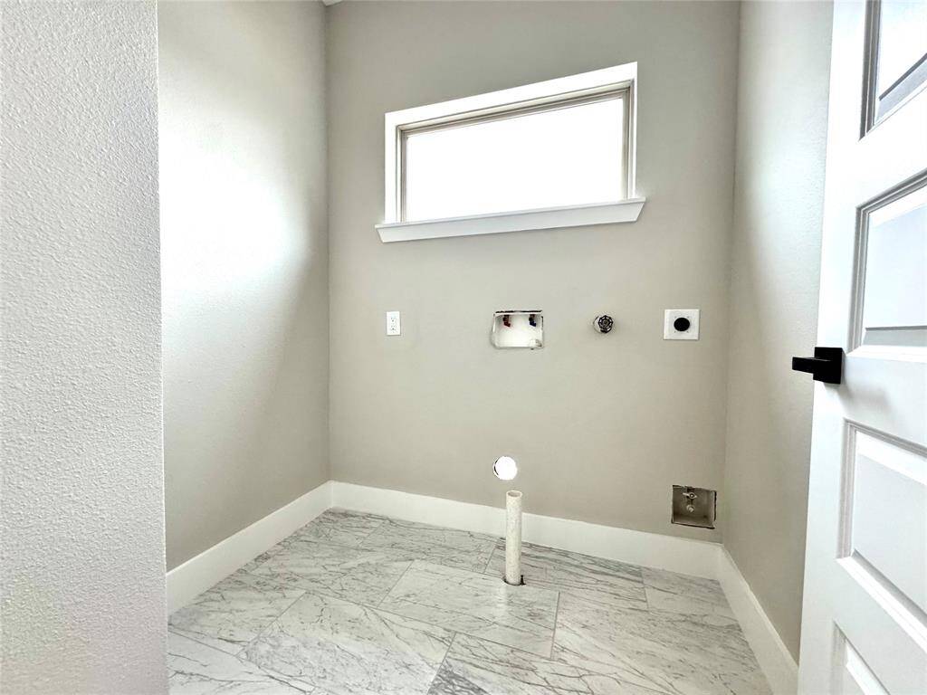 Laundry room is conveniently located upstairs.