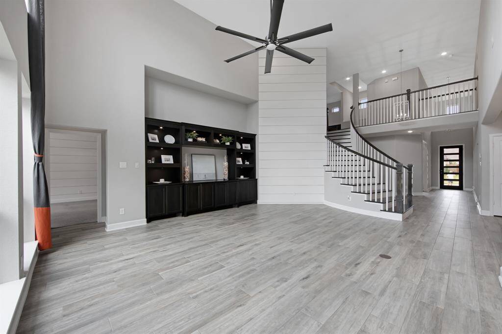 The staircase and catwalk have decorative square wood Spindles and square Newells ($1,220.00) which accentuate the downstairs view of the second floor.  There are 2 clean line entry light fixtures ($492.00).