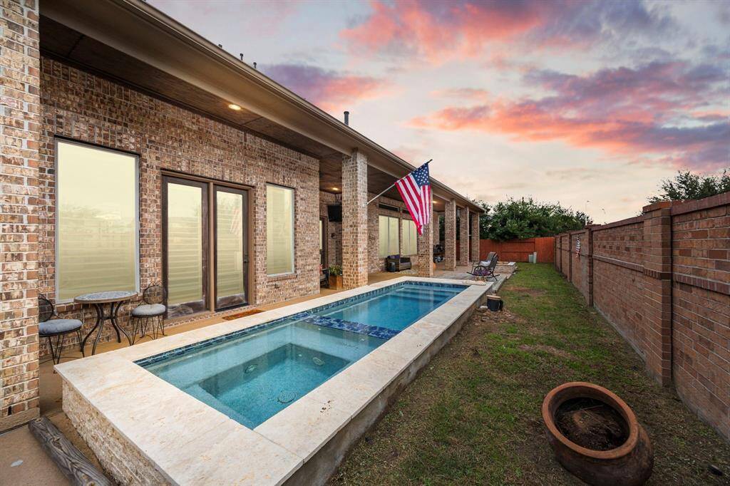 Dive into your private backyard oasis, featuring a sparkling pool, cozy firepit, and spacious covered patio—perfect for unforgettable summer evenings.