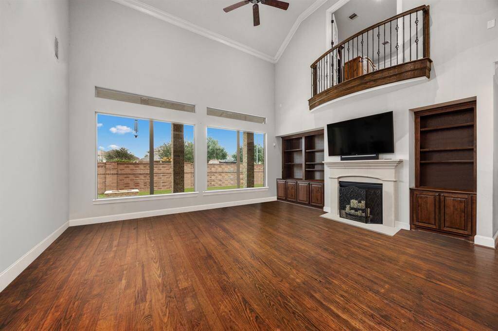 Experience elegant living with hardwood floors and custom built-in cabinets.