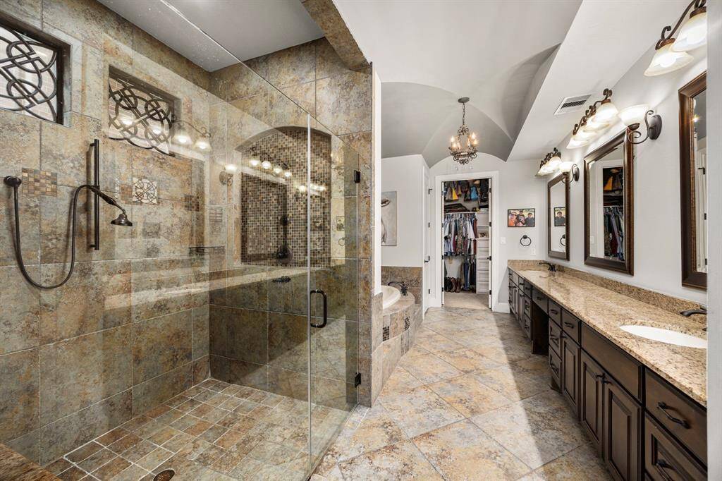 Primary bath features double sinks over size walk in shower , garden tub and great closet storage