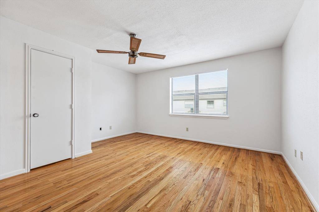 Spacious primary bedroom. Door pictured left, access to the primary bath and walk in closet