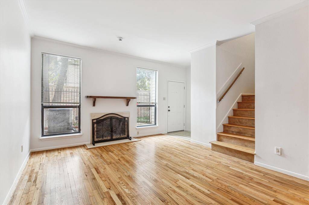 Additional view of the living room and front door. Not pictured next to the front door, powder room to the right