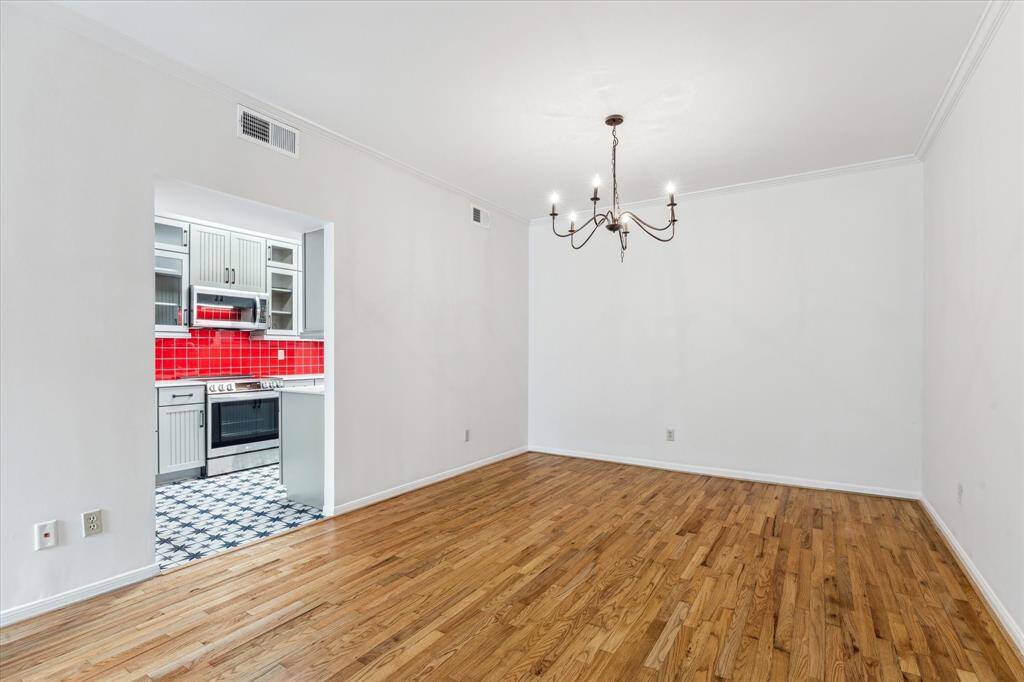 Sizable dining room with centrally located chandelier and convenient access to the kitchen