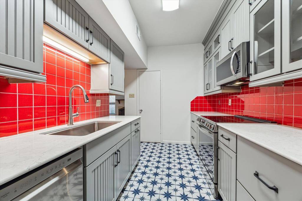 Additional view of the kitchen. Door pictured center, walk in pantry with shelves and ample storage