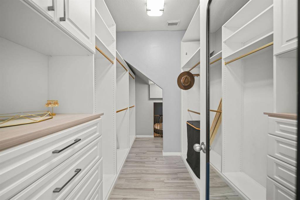 Custom primary closet with access to under stair dog kennel