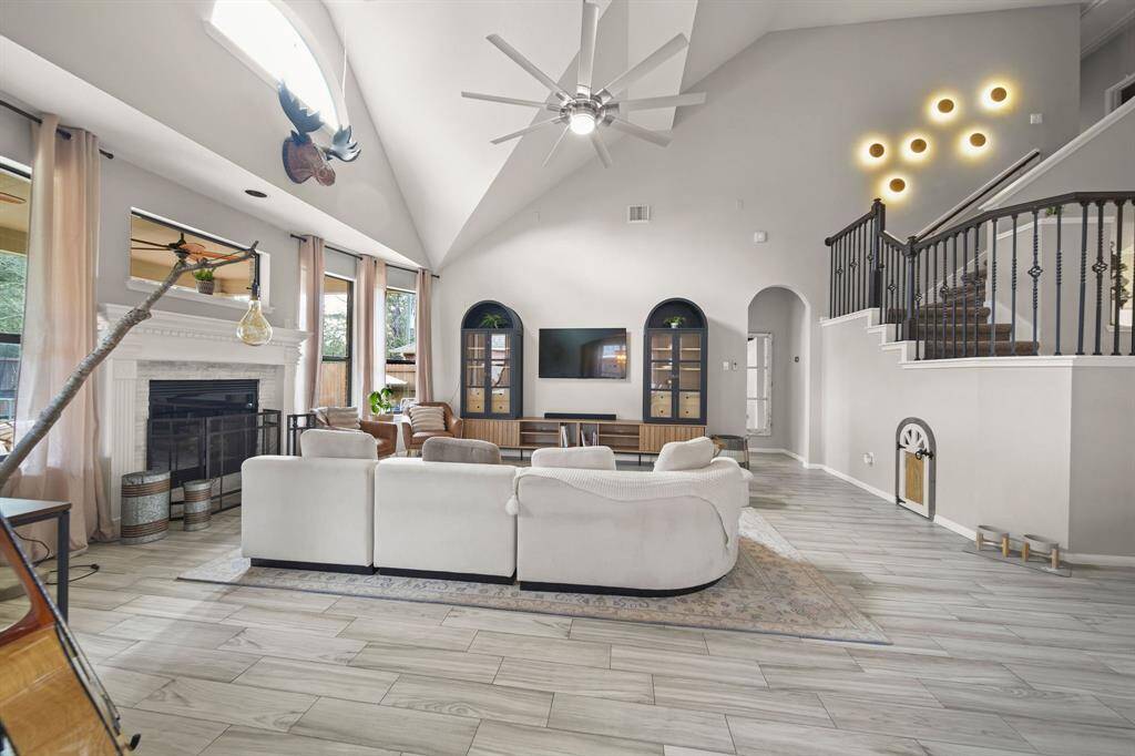 Elegant staircase with wrought iron railing leads to the second floor, featuring a charming built-in dog door.