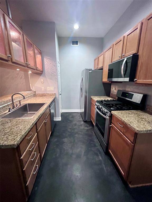 Kitchen w stainless appliances and pantry