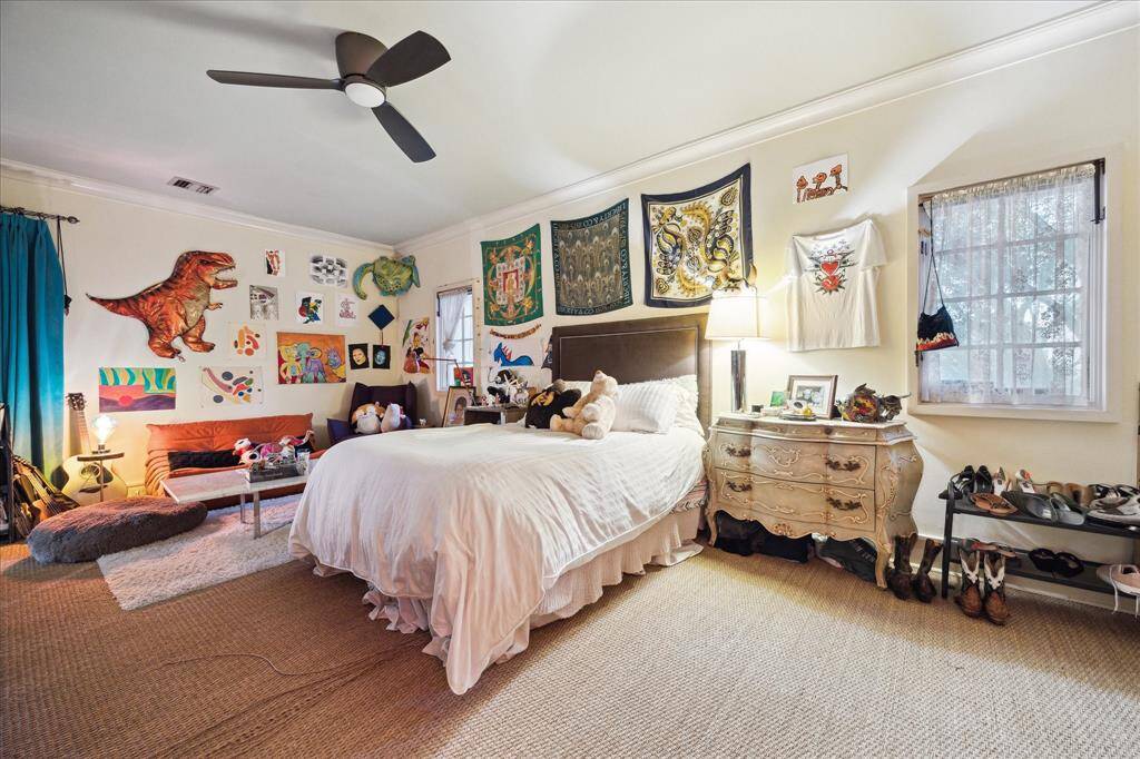 The second bedroom is spacious, has windows for natural lighting, a ceiling fan and expansive walls to display art.