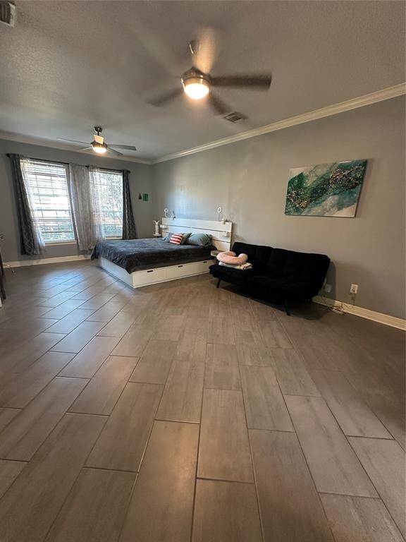 Spacious master bedroom with stylish tile flooring