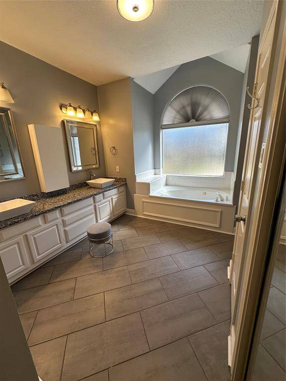 Dual vanities and separate tub and shower in master bathroom