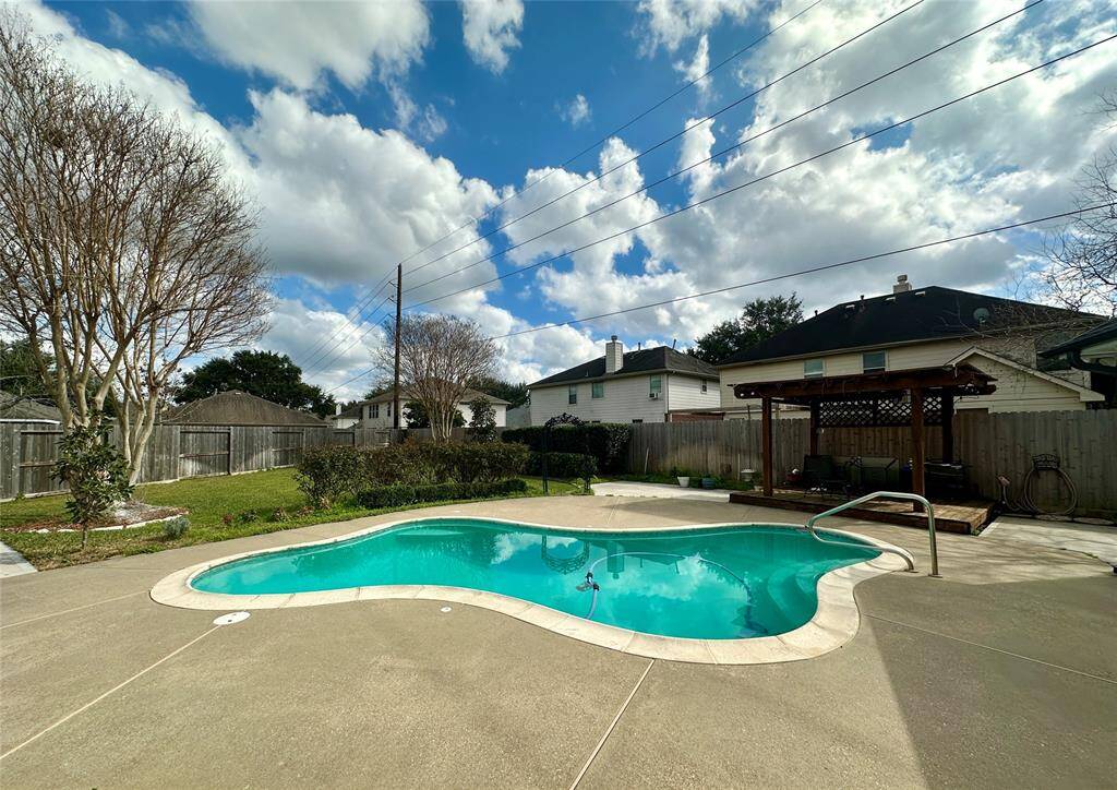 Pool! Patio! Pergola! Greenspace! This is a great back yard!