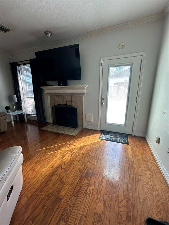 Family Room with hardwood floors, fireplace and door to back patio