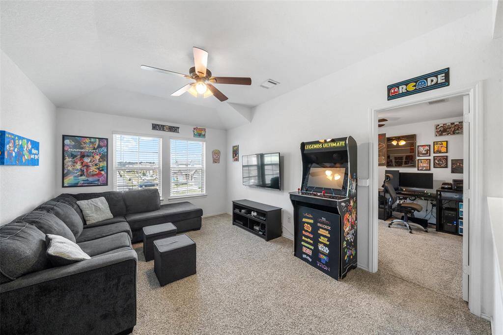 Welcome to your spacious gameroom complete with large windows and ceiling fan.