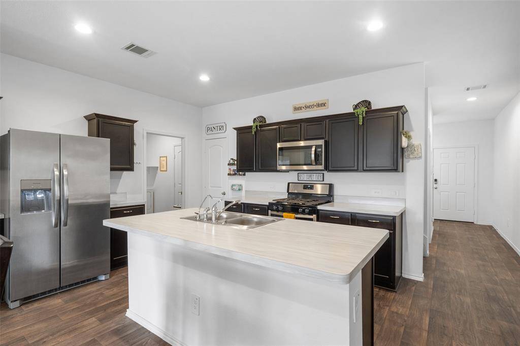 Welcome to the heart of the home, the kitchen! Stainless appliances, ample storage space and direct access to the laundry room.