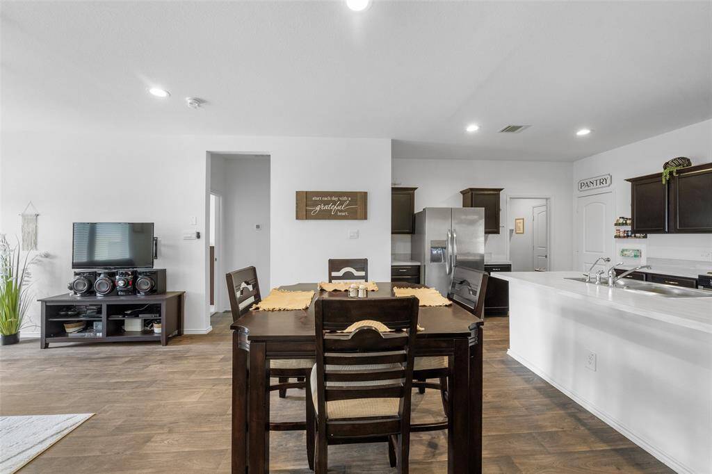 A view into the entrance to the primary suite to the right of the entertainment center.