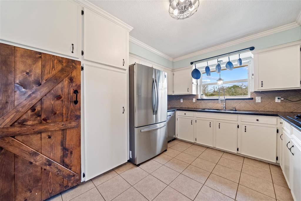 The kitchen unique look with large cabinets and a beautiful custome rustic door!