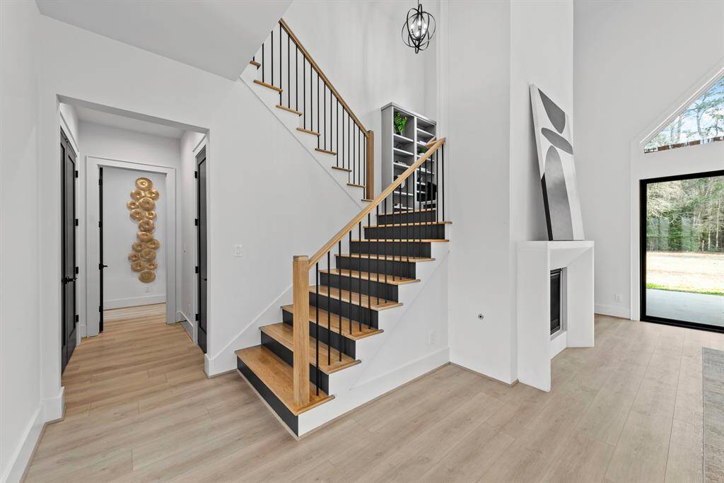 Under stairs huge storage closet with additional double door storage closet across leading to the primary bedroom.