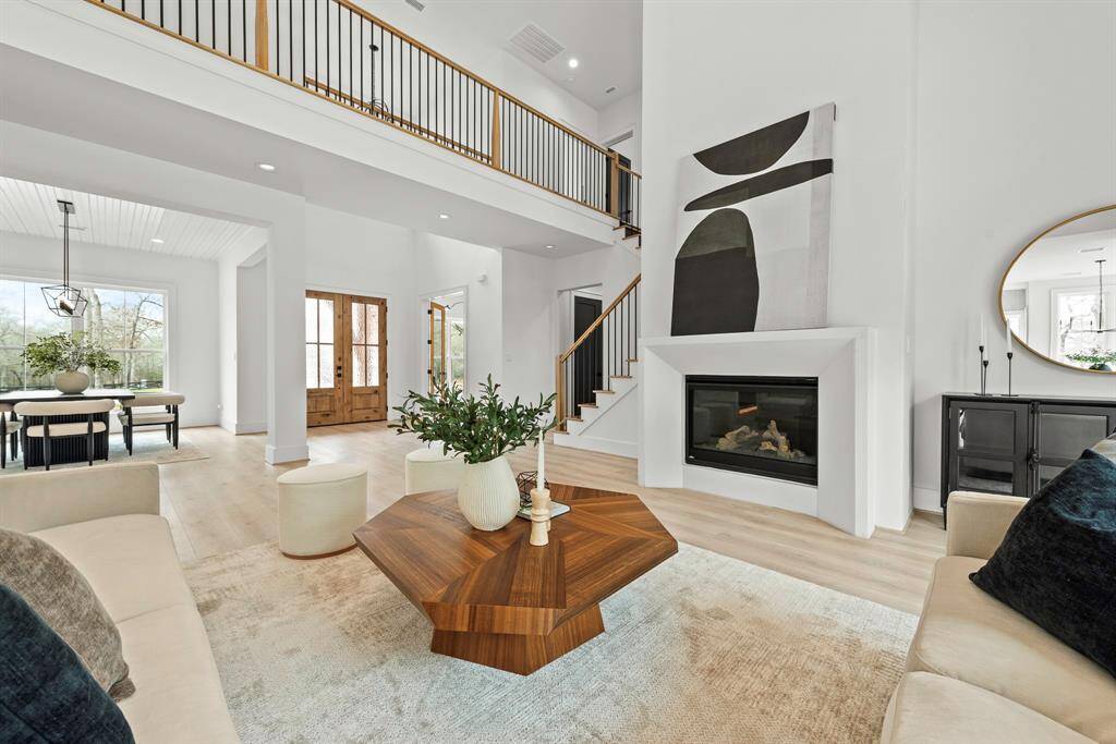 Floor to ceiling fireplace with cast stone mantel.