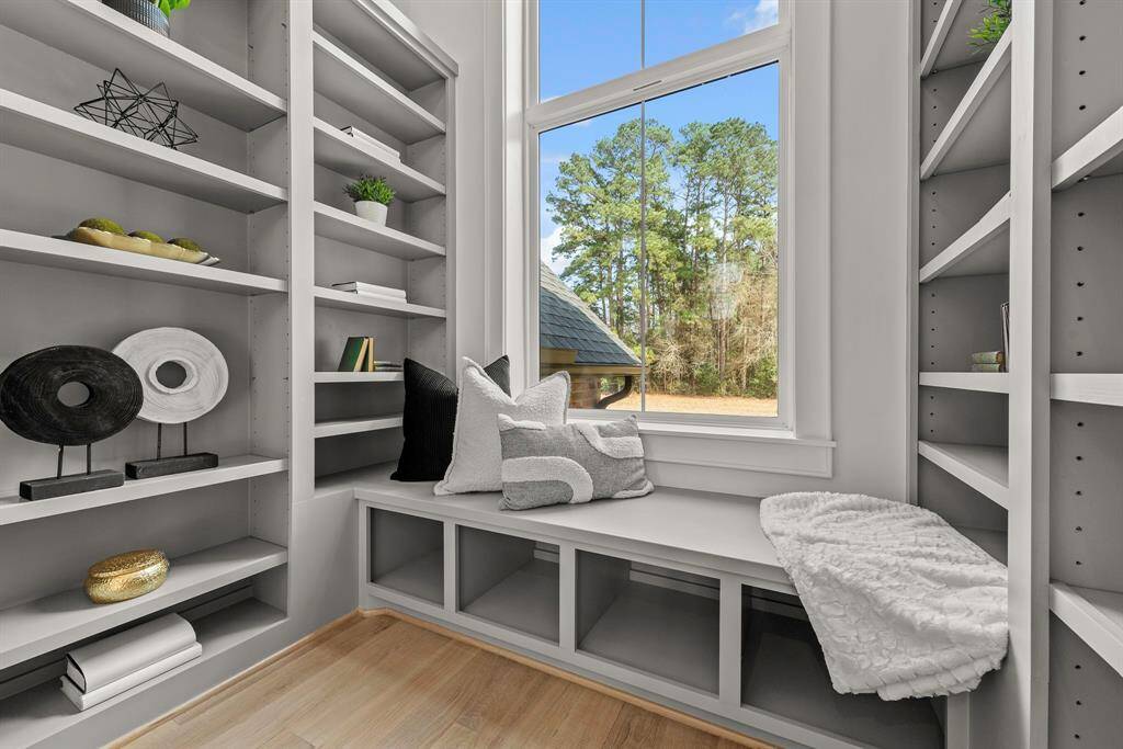 Mid stair library with built in book shelves and window seat with beautiful sweeping views of the backyard.