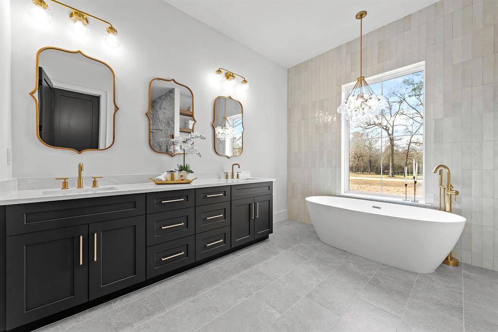 Gold hardware and elegant modern fixtures and lighting provide a true spa feel.