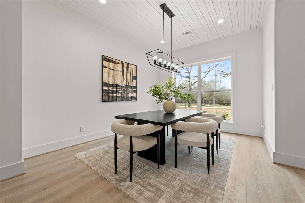 Dining room with bead board ceiling detail.