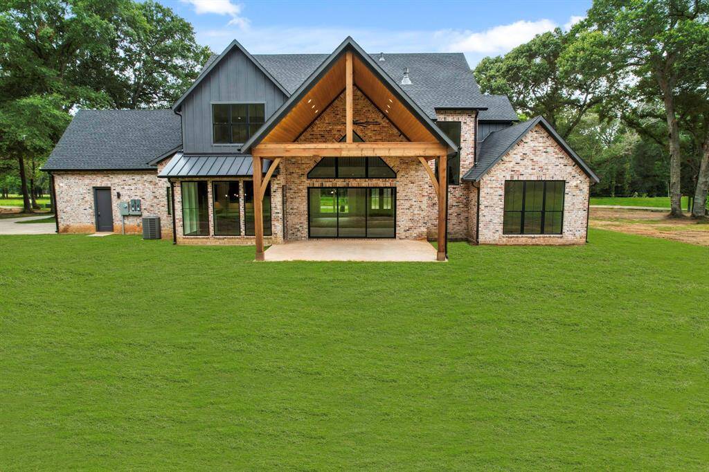 Rear view with pitched back patio, summer kitchen hook ups.