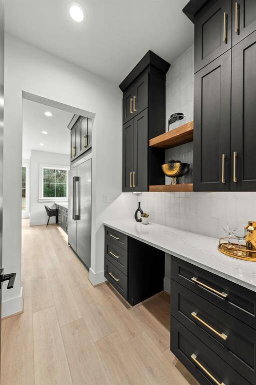 Stunning butlers pantry with beverage slip across from walk in pantry.