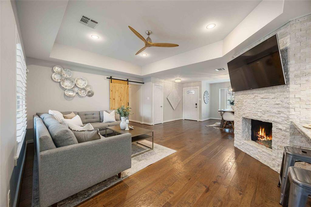 The living room boasts a lovely fireplace for cool winter days and evenings. The gorgeous continuous wood floors add style and sophistication to the living space.