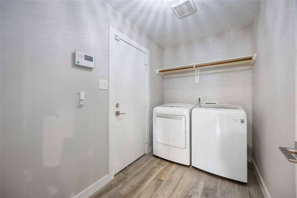 A large indoor utility room offers space for a full-sized washer and dryer.