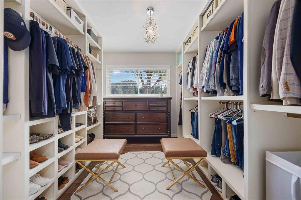 What used to be a fourth bedroom has transformed into an amazing primary closet! Look at all that room for hanging clothes, bags, and shoes, and there is STILL room for a large dresser.