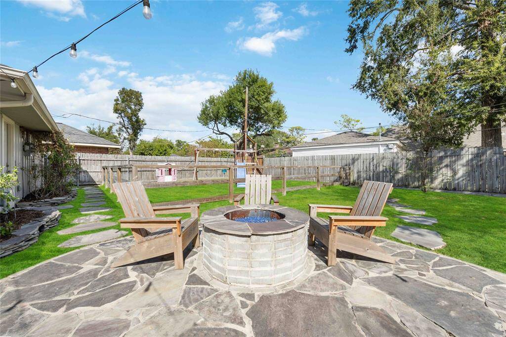 Stone pathways lead to different parts of the yard, helping you reach the play area and flower beds.