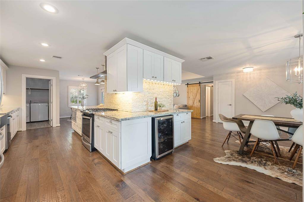 Notice the way the kitchen gives way to a dry bar by way of a wrap-around island. The dining room is to the right.