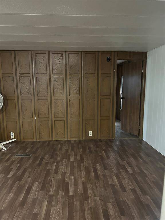 This is the family room with paneled walls and new vinyl wood look flooring